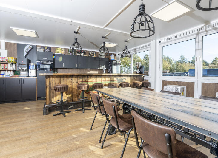 Aufenthaltsraum-innen-mit-Holztisch und Holz Stühlen Aufenthaltsraum-innen-mit-Holztisch und Holz Stühlen