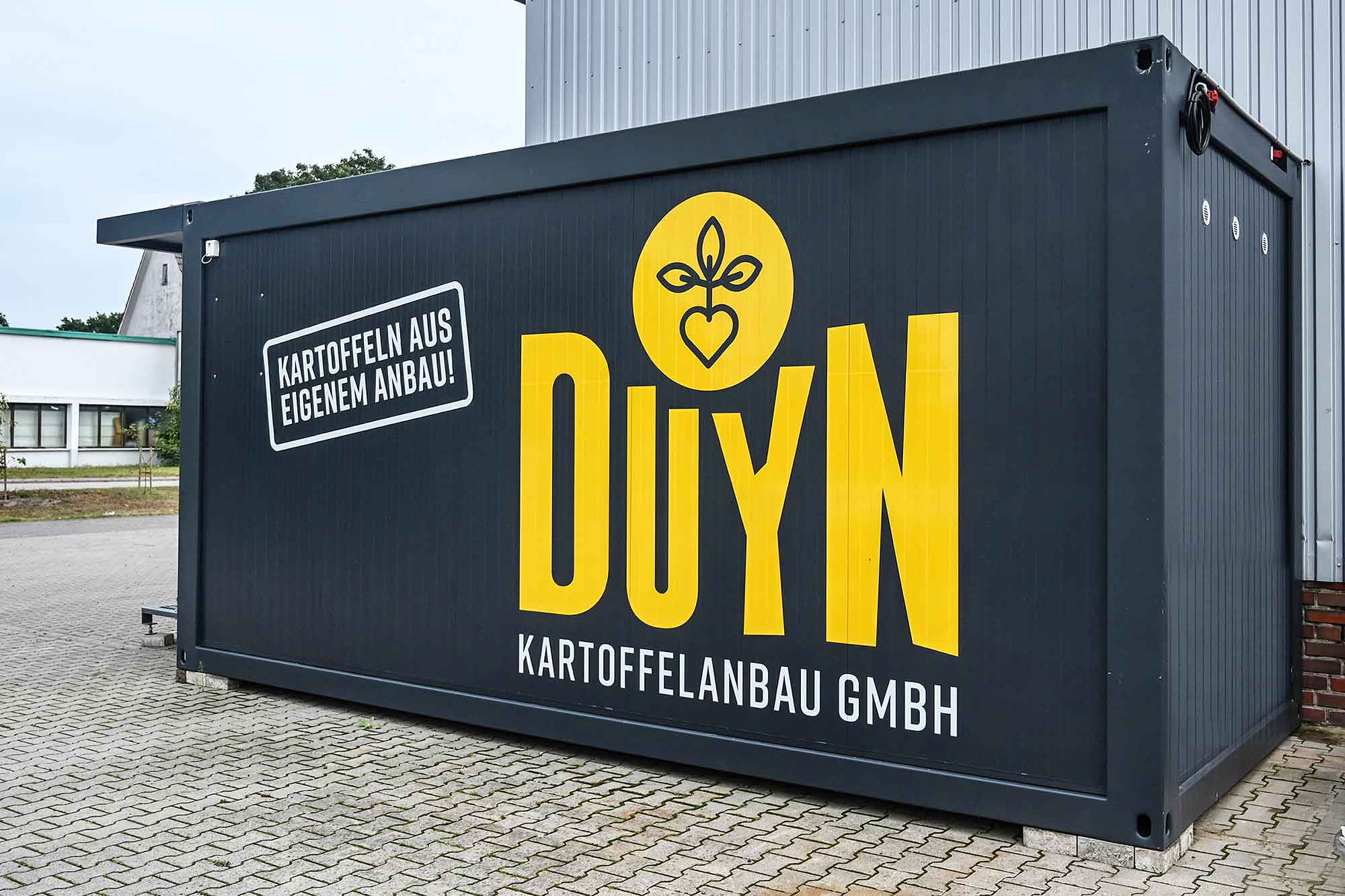 Salgscontainer i antracit med gul logo