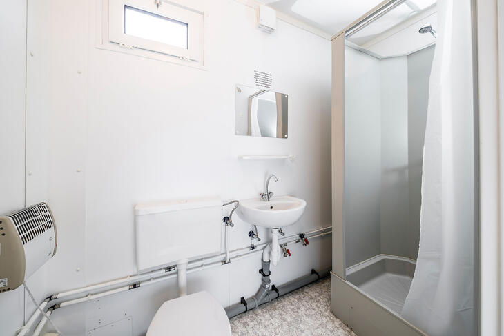 Enkel badeværelse med toilet, vask og bruser