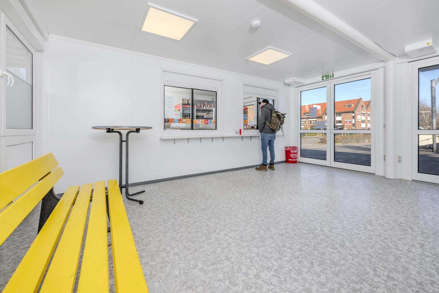 Insidan av den tillfälliga modulbyggnaden med kiosk och vänthall Insidan av den tillfälliga modulbyggnaden med kiosk och vänthall