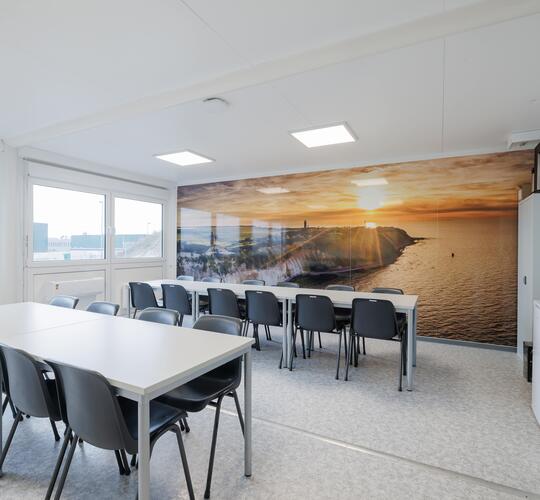 Insidan av en personalbod med bord och stolar