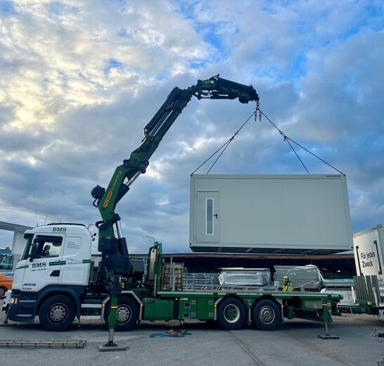 Kranbilen som lyfter modulerna på plats