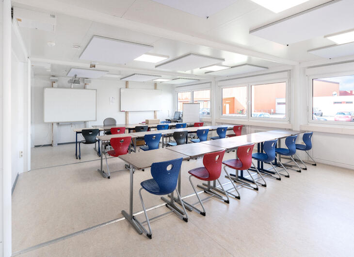 Klassrum med röd och blå stolar Klassrum med röd och blå stolar