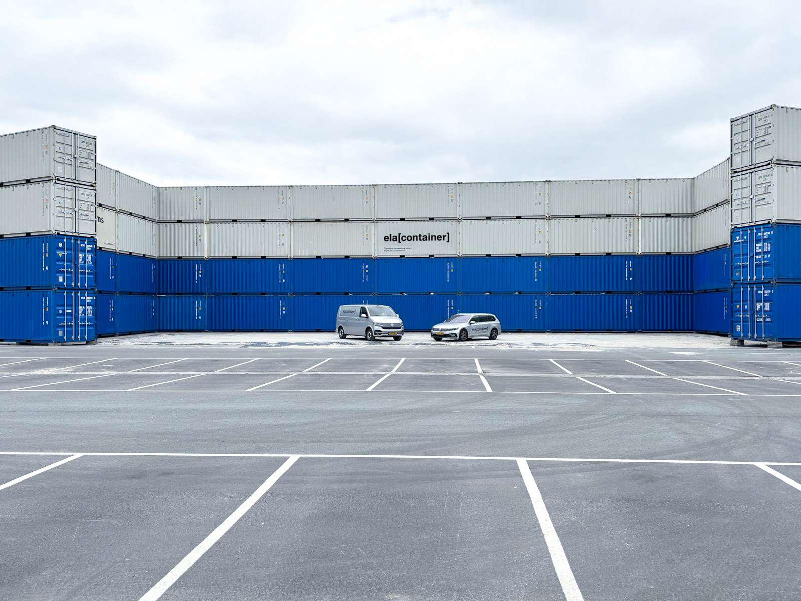 Two ELA vehicles in front of the container wall are an impressive way to emphasise the height and scale of the project.