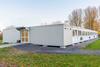 Twenty-four containers provide space for classrooms and staff work areas, while two sanitary units offer ample facilities for pupils